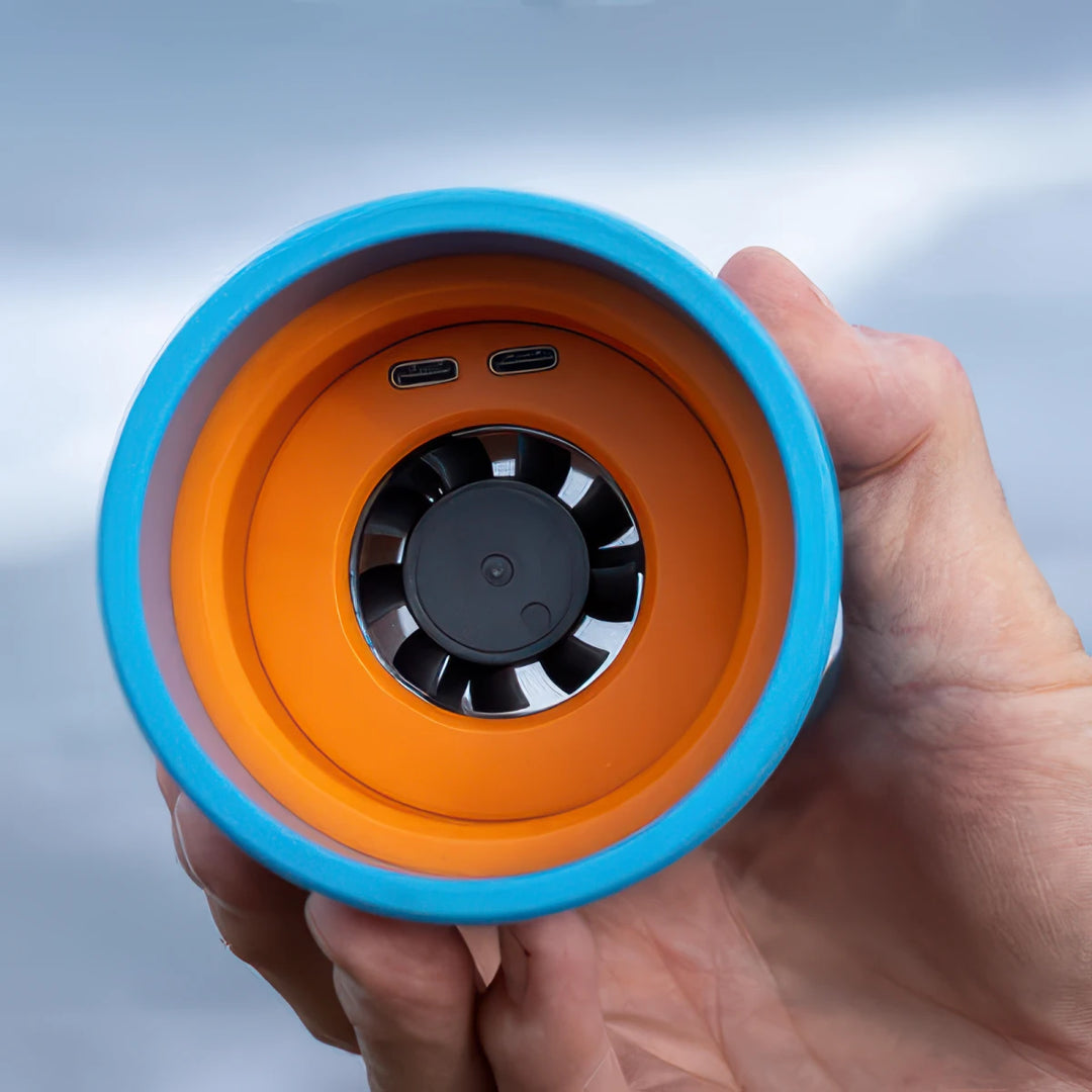 Hand holding a SURFDRY Original with a fan inside against a light gray background